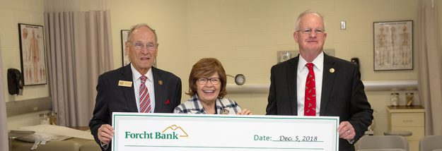 forcht family with president of the university of the cumberlands holding a big check