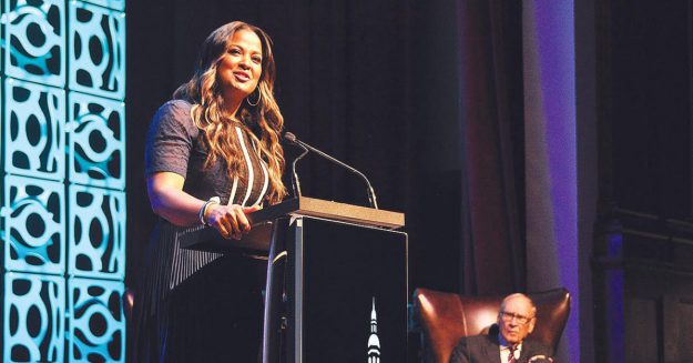 Forcht: a woman in a navy dress speaking
