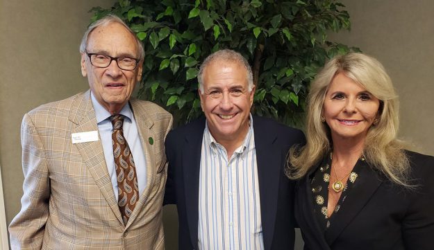 Terry Forcht and Mrs. Debbie with anchor Peter King smiling at the camera