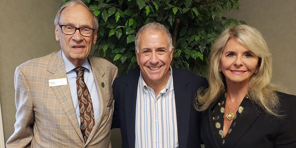 Terry Forcht and Mrs. Debbie with anchor Peter King smiling at the camera