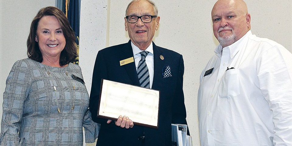 Corbin: two men and a woman smiling at the camera